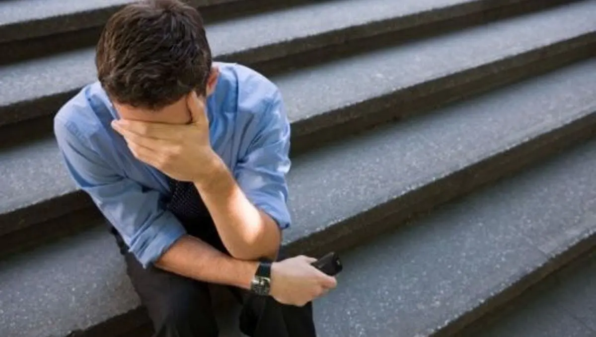 Un homme souffrant de dépression, assis sur des marches.