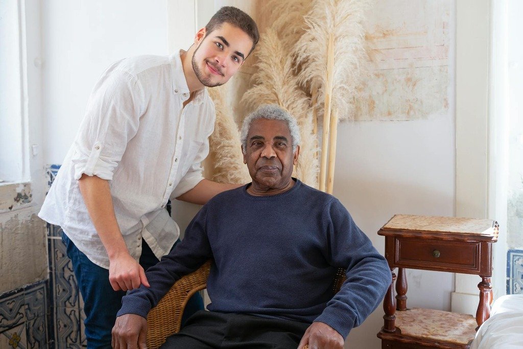 A young adult and senior man enjoying a moment in a cozy Portuguese living room.